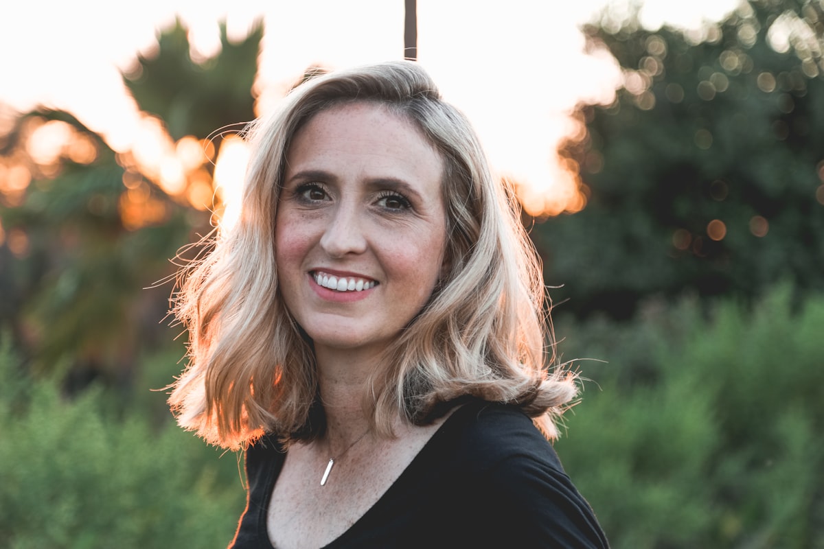 A woman smiling in golden evening light